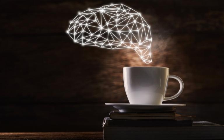 Coffee and a brain shaped effect symbolizing brain activity.