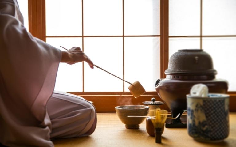A woman pouring water during a Japanese tea ceremony.